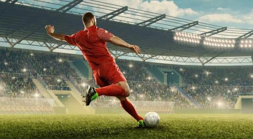 football player kicks the ball